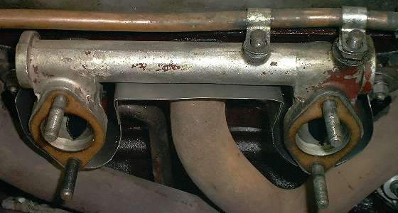 Heat shield between intake and exhaust manifolds